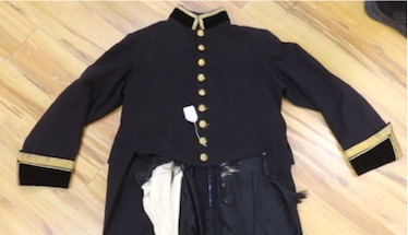 A military black wool dress uniform, with gold decorative braiding